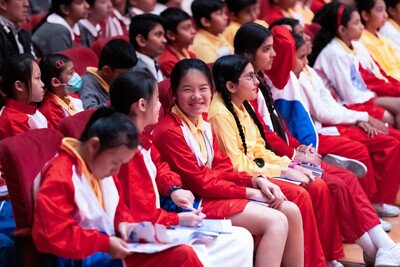 Students smiling in a concert hall